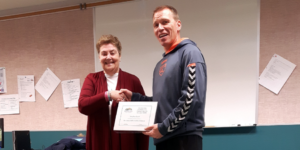 ADLC Teacher Eliise Jeffers presenting Bentley School teacher Stephen Lush the Exemplary Community Partner Award Oct 2018