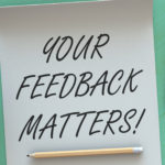 Your Feedback Matters, message on paper, smart phone and coffee on table